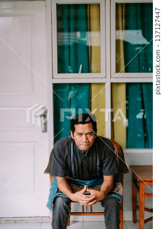 Pensive Asian Man Sitting by Door and Window 137127447