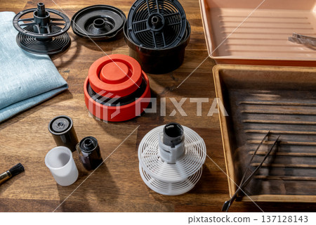 Equipment for analog photography, developing tray, tongs in the tray, film roll. Equipment for analog photography, developing tray, tongs in the tray, film roll. 137128143