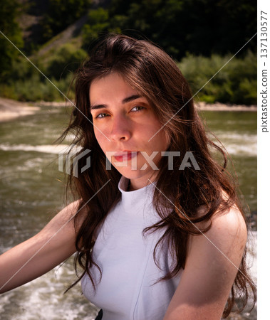 Natural Portrait of Young Woman by River in Soft Daylight 137130577