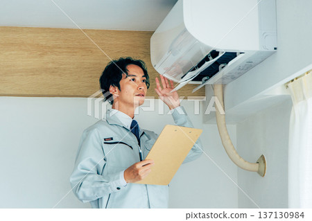 Workers inspecting air conditioners Workers inspecting air conditioners 137130984