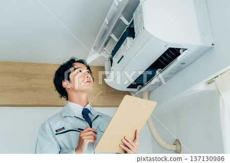 Workers inspecting air conditioners Workers inspecting air conditioners 137130986