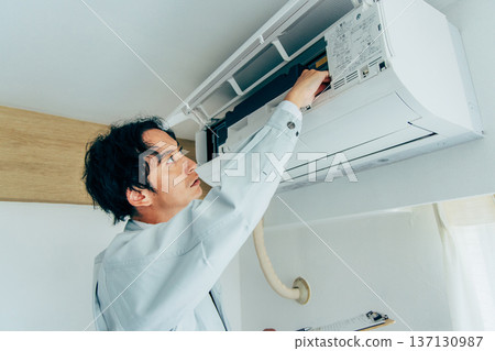 Workers inspecting air conditioners 137130987