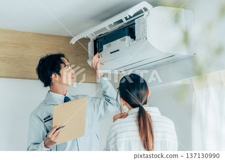Workers inspecting air conditioners Workers inspecting air conditioners 137130990