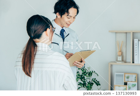 Workers inspecting air conditioners 137130993