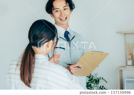 Workers inspecting air conditioners 137130996