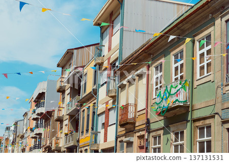 Festive bunting and lanterns decorate a narrow street for summer festival in June San Juan 137131531