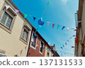 Festive bunting and lanterns decorate a narrow street for summer festival in June San Juan 137131533