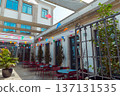 A courtyard, red chairs, and a large potted plant decorated for summer festival in June San Juan 137131535