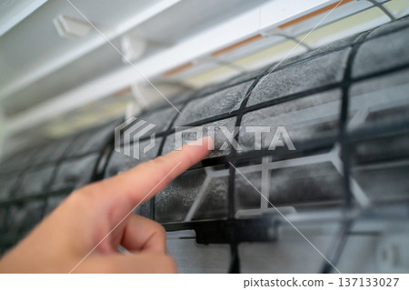 Rub the dust on the air conditioner filter with your finger Rub the dust on the air conditioner filter with your finger 137133027