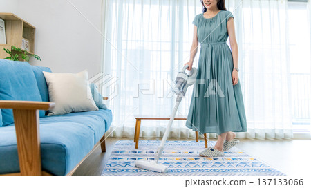Middle-aged woman cleaning in the living room 137133066