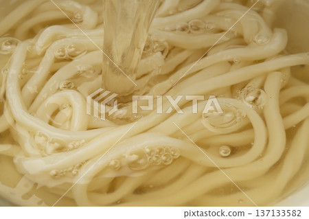 將高湯淋在烏龍面上，再淋上高湯，最後加入麵條湯。 137133582