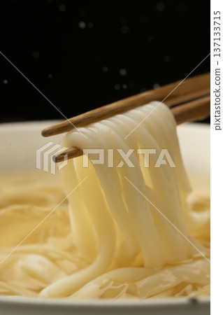 Pick up cold udon noodles with chopsticks Pick up cold udon noodles with chopsticks 137133715