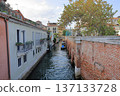 Old brick wall along a canal in Venice 137133728