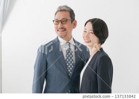 men and women wearing suits 137133842