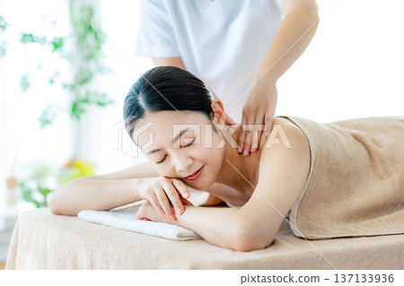Middle-aged woman receiving beauty treatment 137133936