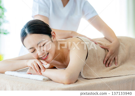Middle-aged woman receiving beauty treatment Middle-aged woman receiving beauty treatment 137133940