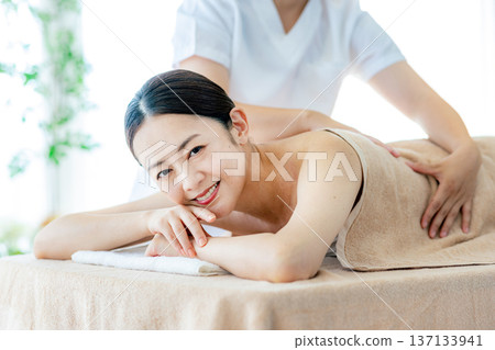 Middle-aged woman receiving beauty treatment 137133941
