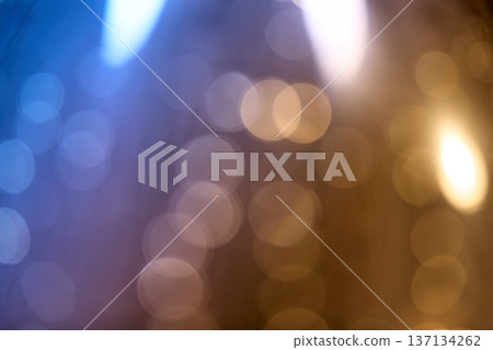 Soft out-of-focus light spheres in blue and warm amber tones creating a dreamy abstract texture Soft out-of-focus light spheres in blue and warm amber tones creating a dreamy abstract texture 137134262