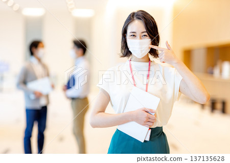 Young woman wearing a mask in the office 137135628