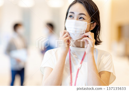 Young woman wearing a mask in the office Young woman wearing a mask in the office 137135633