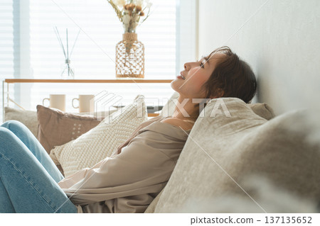 Stylish housewife Asian woman relaxing on the sofa in the living room 137135652