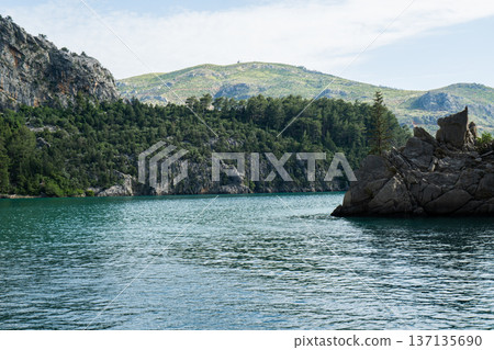 Panoramic Landscape view on green canyon Antalya Turkey with turquoise water mountain cliffs and green forest. Showcasing natural beauty travel tourist destination. Vacation concept 137135690
