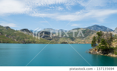 Panoramic Landscape view on green canyon Antalya Turkey with turquoise water mountain cliffs and green forest. Showcasing natural beauty travel tourist destination. Vacation concept 137135694