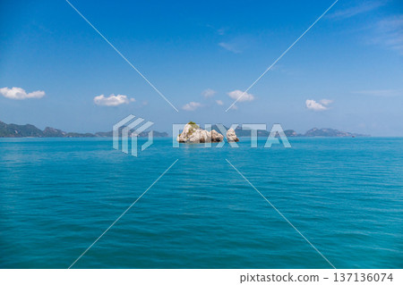 Turquoise sea with limestone islets in Ang Thong Marine Park Thailand, calm tropical waters and distant islands under clear blue sky, natural seascape from boat with wide open view Turquoise sea with limestone islets in Ang Thong Marine Park Thailand, calm tropical waters and distant islands under clear blue sky, natural seascape from boat with wide open view 137136074