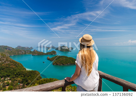 Young woman standing on viewpoint overlooking Ang Thong Marine National Park islands in Thailand 137136092