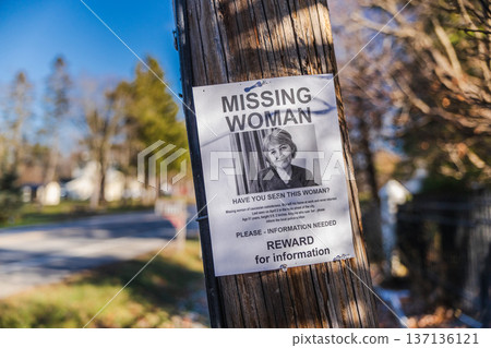 Missing woman reward poster attached to wooden utility pole in suburban neighborhood USA Missing woman reward poster attached to wooden utility pole in suburban neighborhood USA 137136121