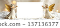Christmas angels holding blank card in snowy winter background 137136377
