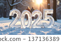 Large 2025 ice sculptures gleam in the snowy park, surrounded by winters beauty. A family walks in the distance, bundled up and enjoying their holiday outing 137136389