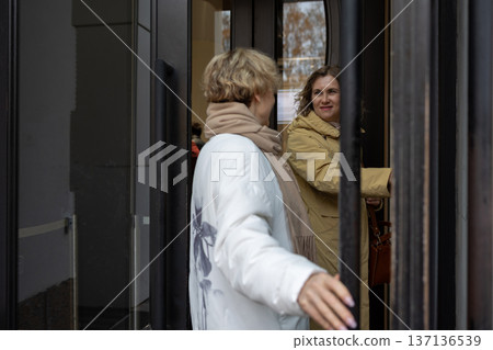 Mobility. Mature women walking side by side discussing daily topics with expressive gestures  137136539
