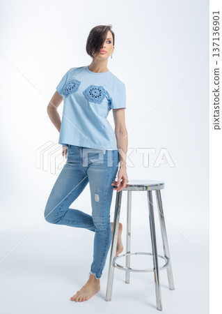 Beautiful woman of model appearance. Girl in blue clothes on grey background. Pretty female with trendy makeup posing in studio. Vertical photo. High quality photo Beautiful woman of model appearance. Girl in blue clothes on grey background. Pretty female with trendy makeup posing in studio. Vertical photo. High quality photo 137136901