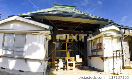 The main hall and shrine office of Tokoji Temple in Japan against a blue sky in Tokyo The main hall and shrine office of Tokoji Temple in Japan against a blue sky in Tokyo 137137303