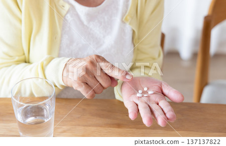 senior woman taking medicine senior woman taking medicine 137137822