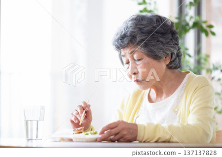 Senior eating 137137828