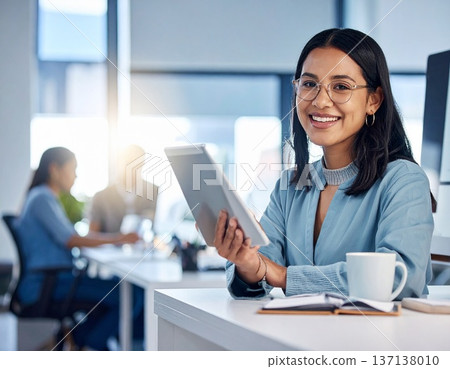 Young businesswoman using a tablet device in a modern office 137138010