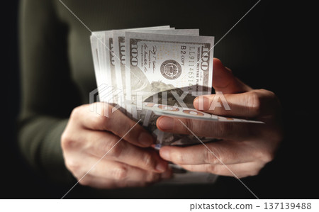 Hands counting US dollar banknote, symbolizing finance, payment, banking Hands counting US dollar banknote, symbolizing finance, payment, banking 137139488
