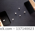 Mini tabletop broom and dustpan on a black background 137140023