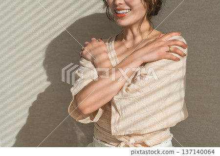 A woman doing the self-hug pose in yoga (mental care, self-esteem) A woman doing the self-hug pose in yoga (mental care, self-esteem) 137140064