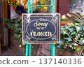 sorry we are closed sign hanging outside a restaurant, store, office or other 137140336