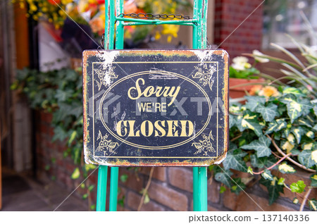 sorry we are closed sign hanging outside a restaurant, store, office or other sorry we are closed sign hanging outside a restaurant, store, office or other 137140336