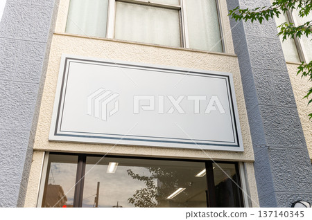 Large blank billboard on a street wall, banners with room to add your own text 137140345