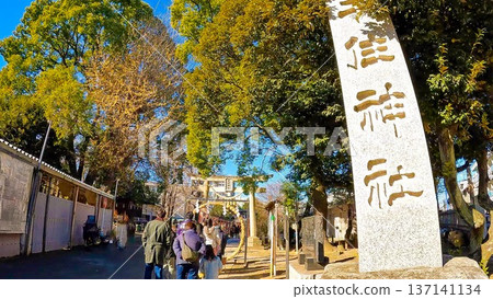 The stone pillars of the historic Senju Shrine and its grounds under a blue sky 137141134