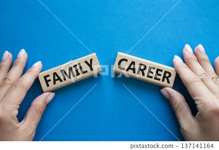 Family or Career symbol. Concept word Family or Career on wooden blocks. Businessman hand. Beautiful blue background. Business and Family or Career concept. Copy space 137141164