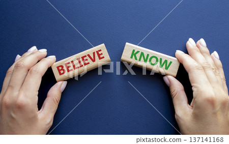 Believe or Know symbol. Concept word Believe or Know on wooden blocks. Businessman hand. Beautiful deep blue background. Business and Believe or Know concept. Copy space Believe or Know symbol. Concept word Believe or Know on wooden blocks. Businessman hand. Beautiful deep blue background. Business and Believe or Know concept. Copy space 137141168