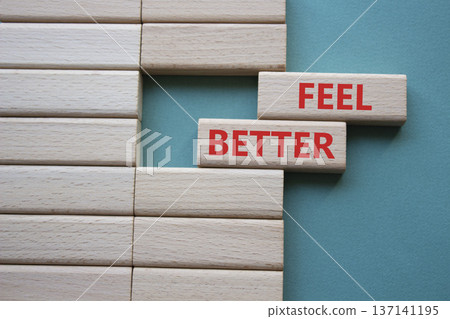 Feel better symbol. Wooden blocks with words Feel better. Beautiful grey green background. Business and Feel better concept. Copy space. Feel better symbol. Wooden blocks with words Feel better. Beautiful grey green background. Business and Feel better concept. Copy space. 137141195