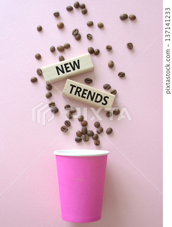 New Trends symbol. Concept word New Trends on wooden blocks. Beautiful pink background with coffee cup. Business and New Trends concept. Copy space New Trends symbol. Concept word New Trends on wooden blocks. Beautiful pink background with coffee cup. Business and New Trends concept. Copy space 137141233