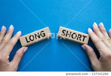 Short vs Long symbol. Concept word Short vs Long on wooden blocks. Businessman hand. Beautiful blue background. Business and Short vs Long concept. Copy space Short vs Long symbol. Concept word Short vs Long on wooden blocks. Businessman hand. Beautiful blue background. Business and Short vs Long concept. Copy space 137141260